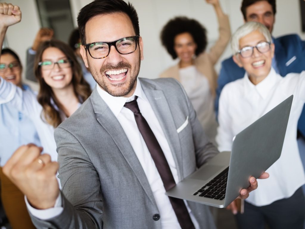 enterprise SEO strategies manager using smartphone and computer at work